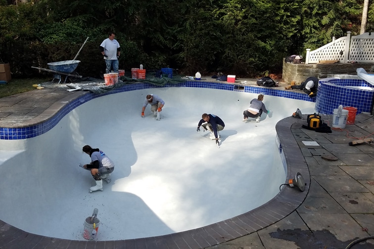 This is a photo of a gunite inground pool restoration in-progress, nearly complete